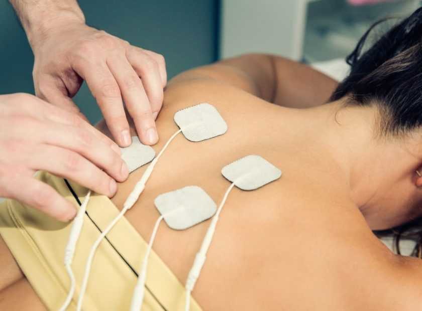 Therapist positioning TENS electrodes